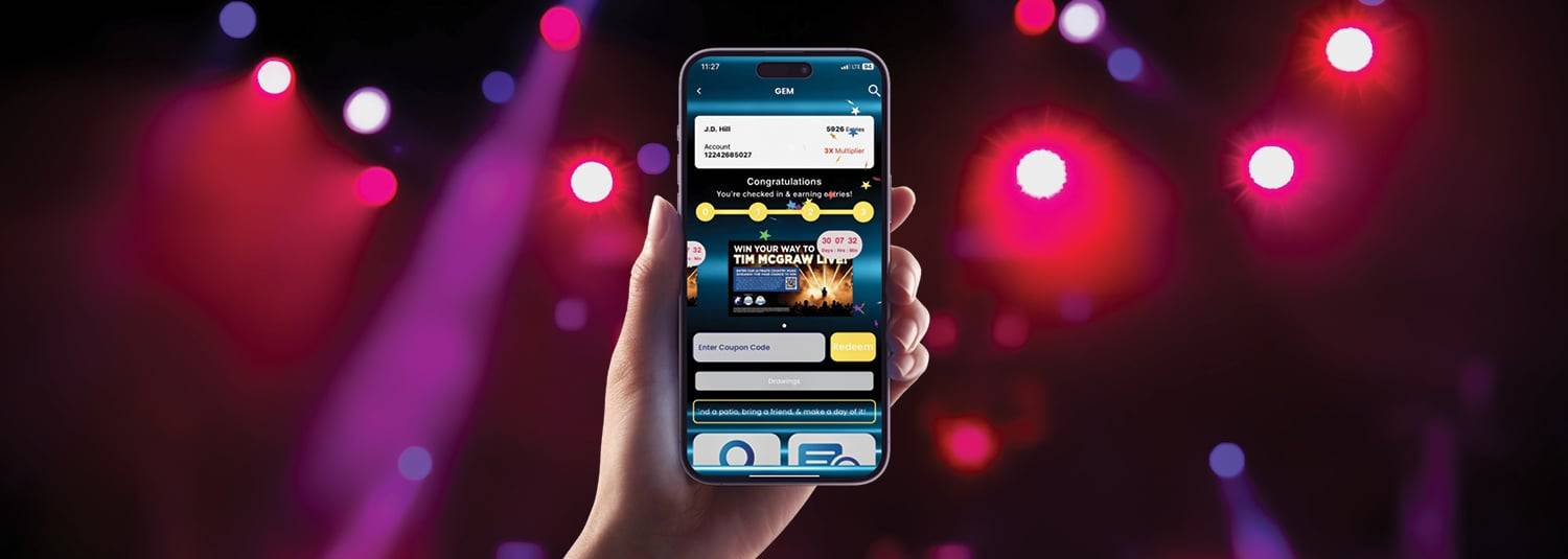 Person holding a phone showcasing the GEM website