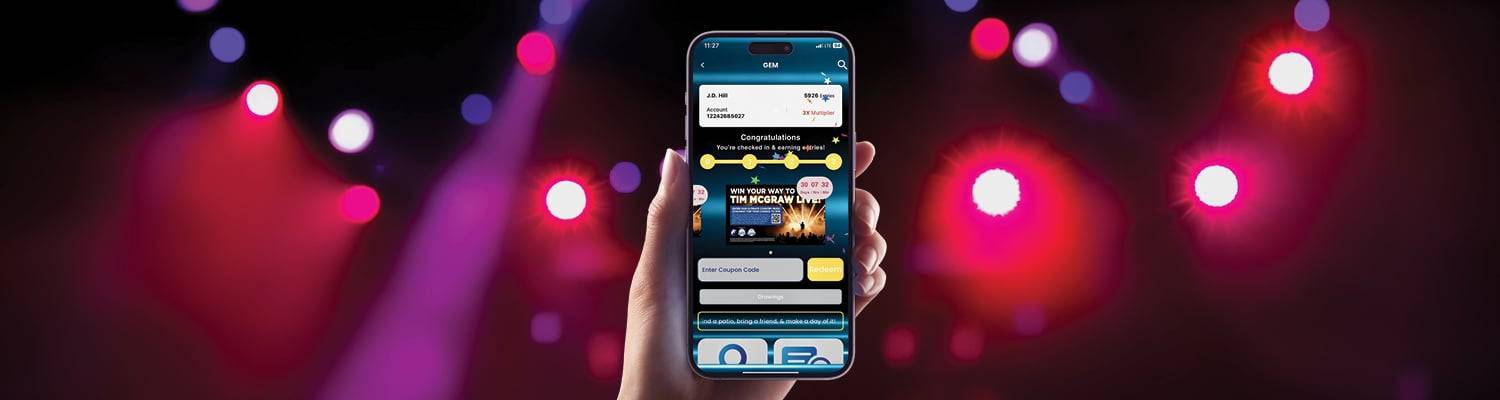 Person holding a phone showcasing the GEM website